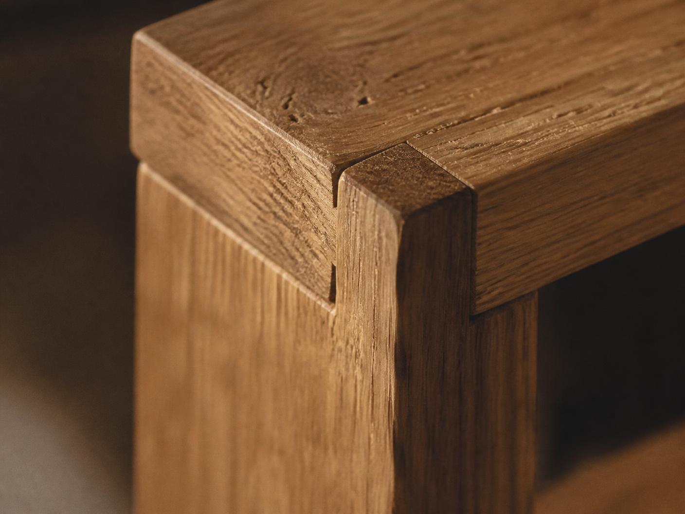 Macro detail of hand-cut oak joinery showing grain and chisel marks